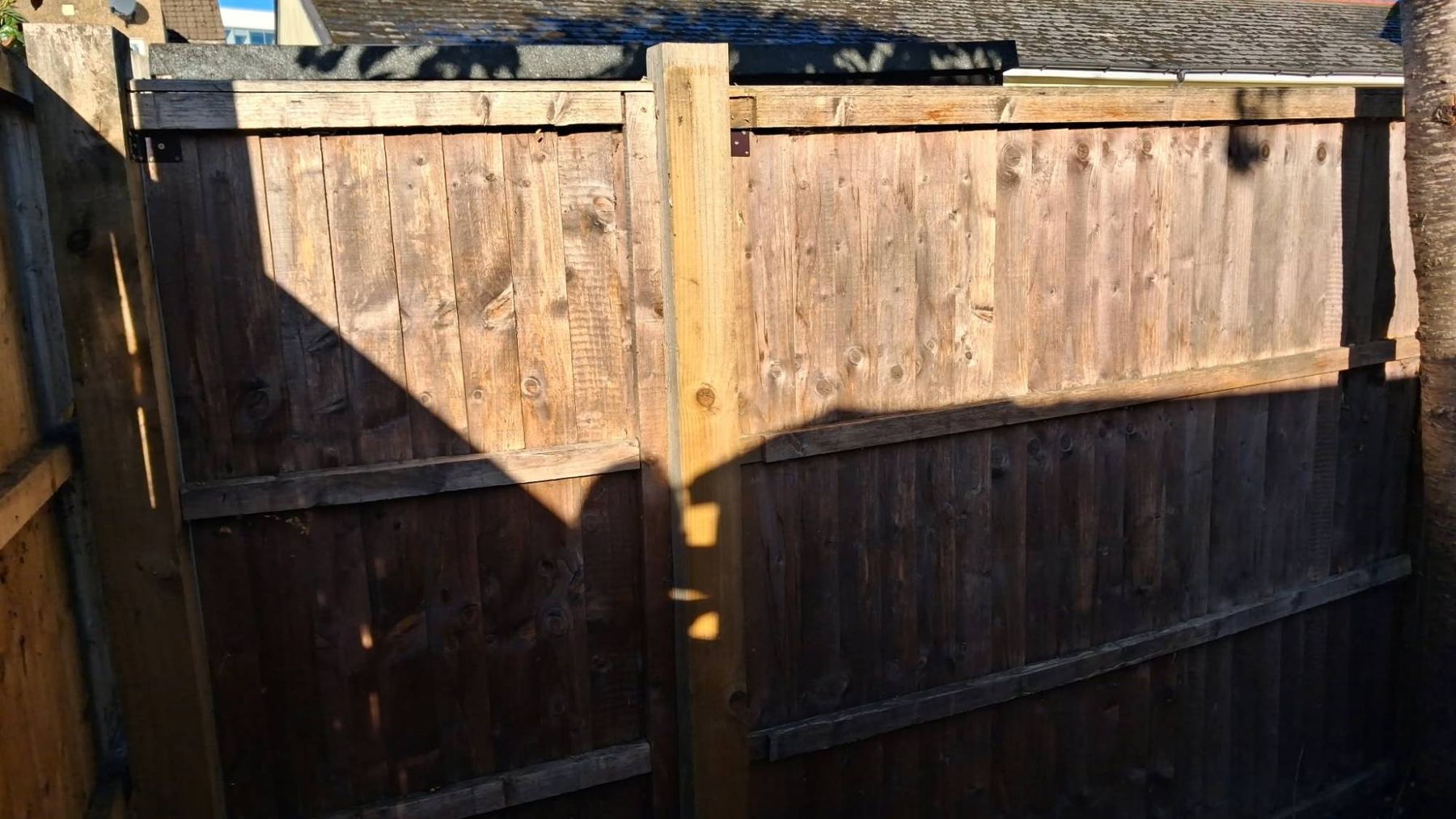 After: fence panels refitted square on a new timber post